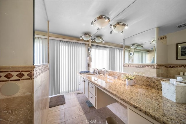21166 E Rimpath Dr, Covina, CA 91724 - full bath with tile walls, tile patterned floors, vanity, and wainscoting