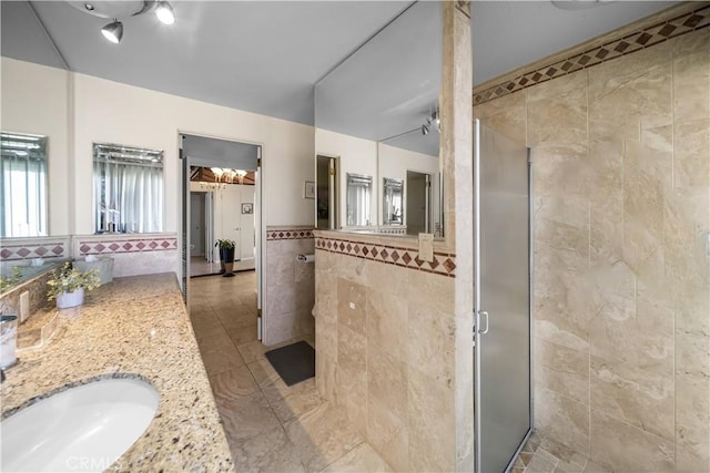 21166 E Rimpath Dr, Covina, CA 91724 - full bath featuring tile walls, a stall shower, vanity, a wainscoted wall, and tile patterned floors