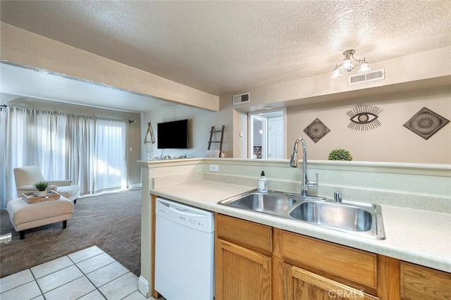 2881 Huntington Blvd Unit 137, Fresno, CA 93721 - kitchen featuring white dishwasher, open floor plan, a sink, a textured ceiling, and light countertops