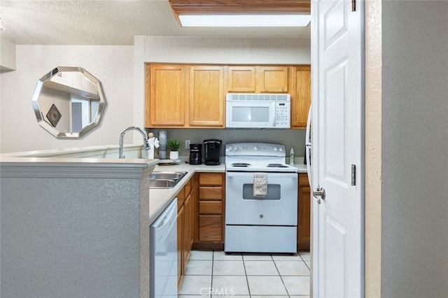 2881 Huntington Blvd Unit 137, Fresno, CA 93721 - kitchen featuring white appliances, light tile patterned floors, a sink, and light countertops