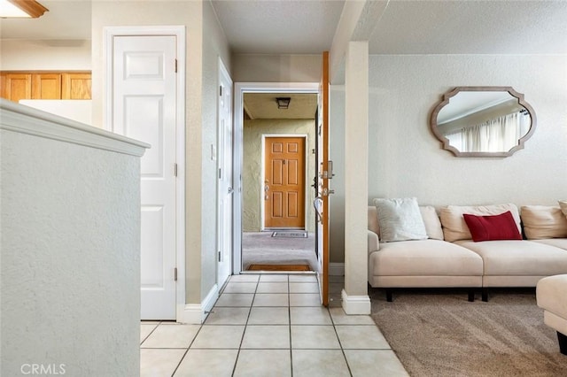 2881 Huntington Blvd Unit 137, Fresno, CA 93721 - corridor with light tile patterned flooring, a textured wall, and baseboards