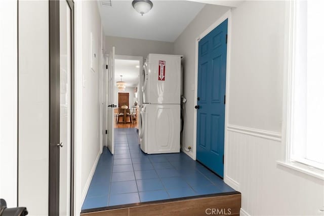 1518 Ocean Ave, Seal Beach, CA 90740 - entryway with stacked washer / drying machine, dark tile patterned floors, and baseboards
