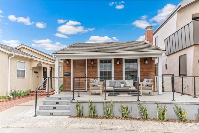 1518 Ocean Ave, Seal Beach, CA 90740 - view of front facade with outdoor lounge area and a chimney