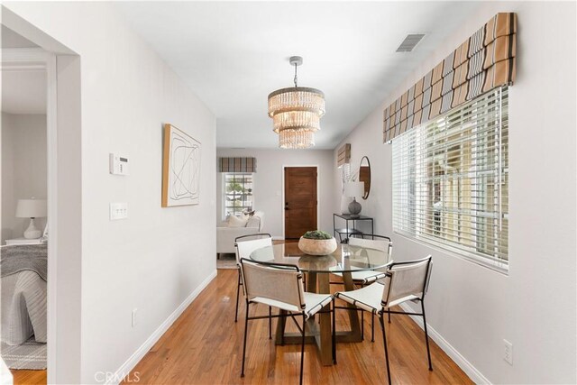 1518 Ocean Ave, Seal Beach, CA 90740 - dining area featuring light wood finished floors, a chandelier, and baseboards