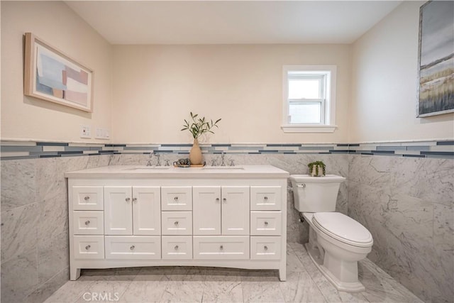 1518 Ocean Ave, Seal Beach, CA 90740 - bathroom featuring tile walls, toilet, wainscoting, marble finish flooring, and double vanity