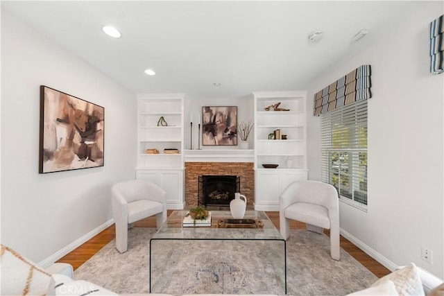 1518 Ocean Ave, Seal Beach, CA 90740 - living area with wood finished floors, baseboards, a fireplace, recessed lighting, and built in shelves