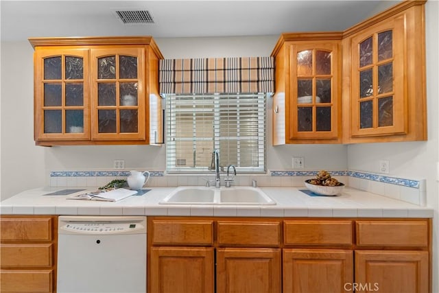1518 Ocean Ave, Seal Beach, CA 90740 - kitchen featuring dishwasher, a sink, glass insert cabinets, and light countertops