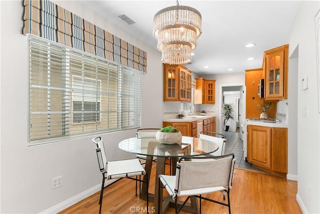 1518 Ocean Ave, Seal Beach, CA 90740 - dining room featuring light wood-style flooring, a chandelier, recessed lighting, and baseboards