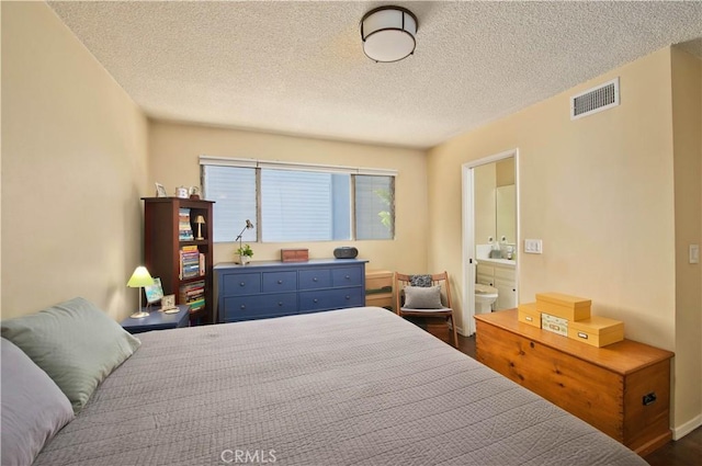 4252 Fair Ave Unit 2, North Hollywood, CA 91602 - bedroom with a textured ceiling, ensuite bath, and dark wood-style floors