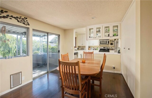 4252 Fair Ave Unit 2, North Hollywood, CA 91602 - dining space featuring a textured ceiling, dark wood-style floors, and baseboards
