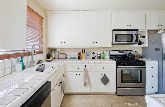 4252 Fair Ave Unit 2, North Hollywood, CA 91602 - kitchen featuring stainless steel appliances, tile counters, a sink, and white cabinets