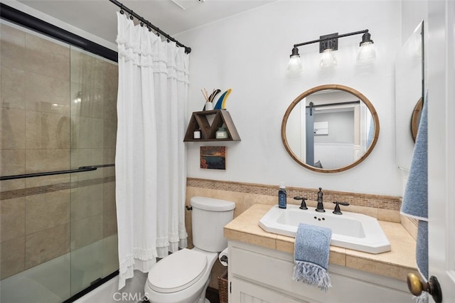 2818 Via Blanco, San Clemente, CA 92673 - bathroom with toilet, combined bath / shower with glass door, vanity, tile walls, and wainscoting