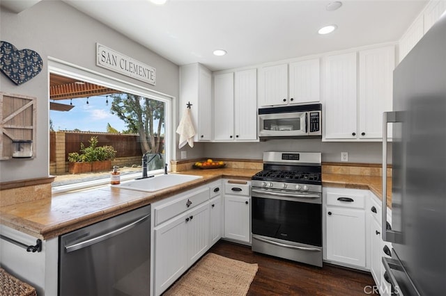 2818 Via Blanco, San Clemente, CA 92673 - kitchen with appliances with stainless steel finishes, a sink, recessed lighting, white cabinetry, and dark wood-type flooring