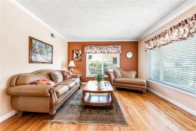 11628 Cedarvale St, Norwalk, CA 90650 - living room with a textured ceiling, crown molding, wood finished floors, and baseboards