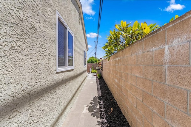 11628 Cedarvale St, Norwalk, CA 90650 - view of side of property with stucco siding and a fenced backyard