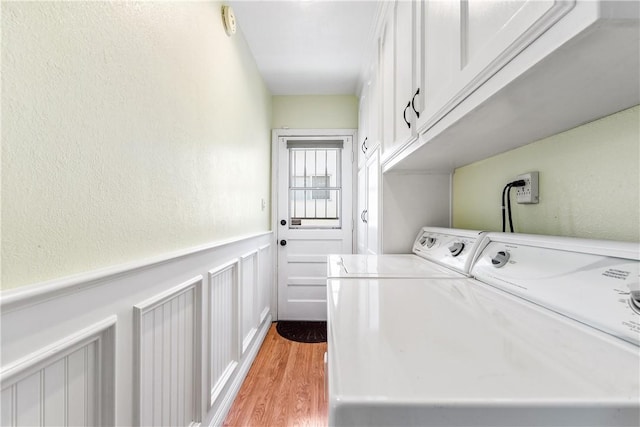 11628 Cedarvale St, Norwalk, CA 90650 - laundry room featuring cabinet space, washing machine and clothes dryer, wainscoting, light wood finished floors, and a decorative wall