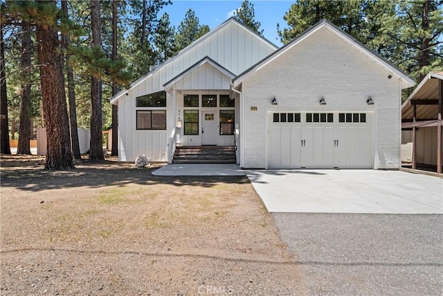 374 Mountainaire Ln, Big Bear Lake, CA 92315 - modern farmhouse with a garage, board and batten siding, concrete driveway, and brick siding