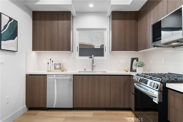 150 S Oak Knoll Ave Unit 103, Pasadena, CA 91101 - kitchen with stainless steel appliances, modern cabinets, a sink, light countertops, and recessed lighting