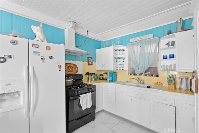 211 S K St, Lompoc, CA 93436 - kitchen featuring white fridge with ice dispenser, black gas stove, open shelves, light marble finish flooring, and wall chimney range hood