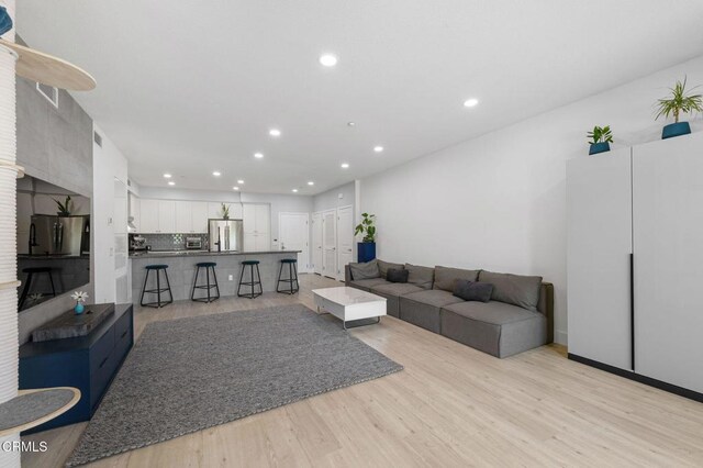 13124 Central Ave Unit 201, Hawthorne, CA 90250 - living room with recessed lighting and light wood-style flooring