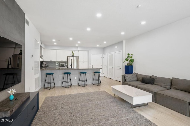 13124 Central Ave Unit 201, Hawthorne, CA 90250 - living area featuring light wood-style floors and recessed lighting