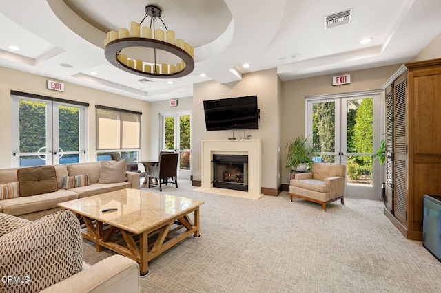 13124 Central Ave Unit 201, Hawthorne, CA 90250 - living room featuring french doors, a fireplace, light colored carpet, a raised ceiling, and recessed lighting