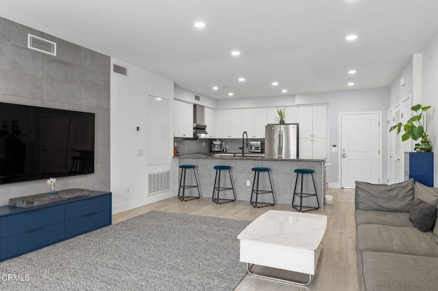 13124 Central Ave Unit 201, Hawthorne, CA 90250 - living room with light wood-style flooring, recessed lighting, and baseboards