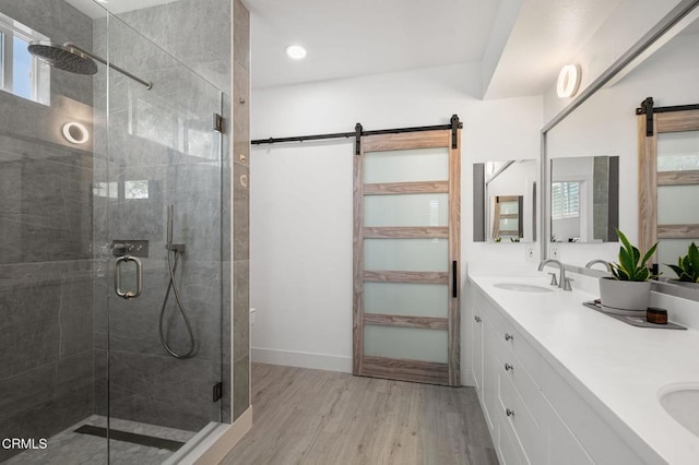 13124 Central Ave Unit 201, Hawthorne, CA 90250 - full bath featuring a stall shower, double vanity, wood finished floors, and baseboards