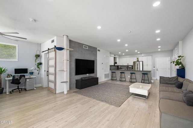 13124 Central Ave Unit 201, Hawthorne, CA 90250 - living room featuring a barn door, light wood-type flooring, recessed lighting, an office area, and a ceiling fan