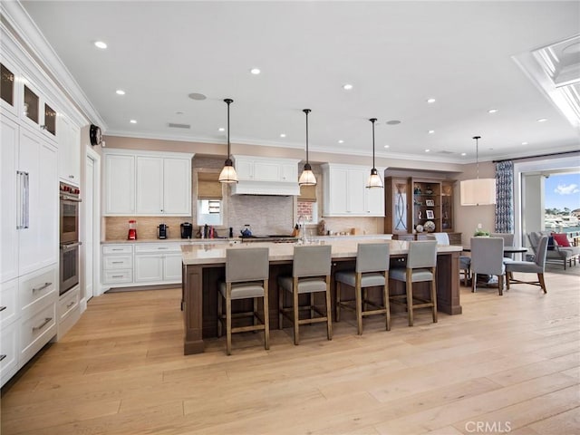 1324 E Balboa Blvd, Newport Beach, CA 92661 - kitchen featuring stainless steel double oven, light countertops, backsplash, ornamental molding, and white cabinets