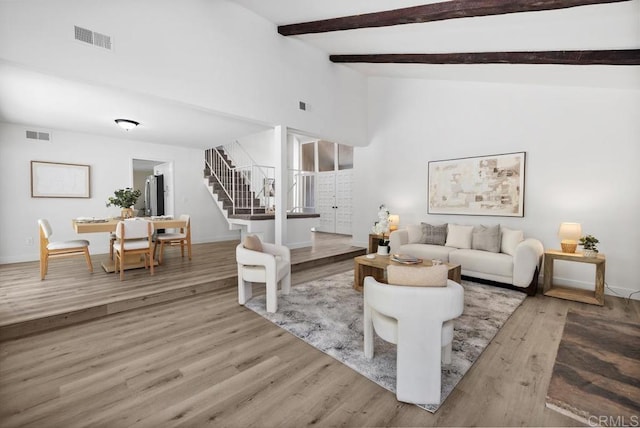 6843 Claremore Ave, San Diego, CA 92120 - living area featuring stairs, wood finished floors, beamed ceiling, baseboards, and high vaulted ceiling