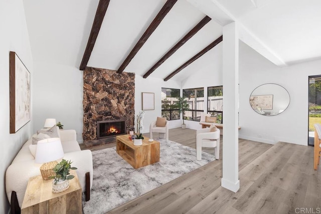 6843 Claremore Ave, San Diego, CA 92120 - living area featuring a stone fireplace, beam ceiling, high vaulted ceiling, wood finished floors, and baseboards