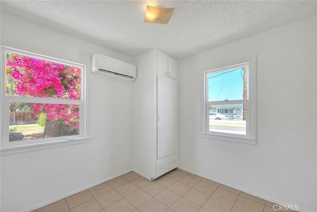 1507 4th St, Norco, CA 92860 - empty room with a wall unit AC, a textured ceiling, baseboards, and light tile patterned floors