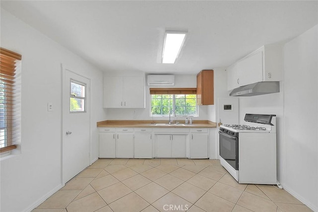 1507 4th St, Norco, CA 92860 - kitchen featuring white gas range, under cabinet range hood, a sink, an AC wall unit, and light countertops