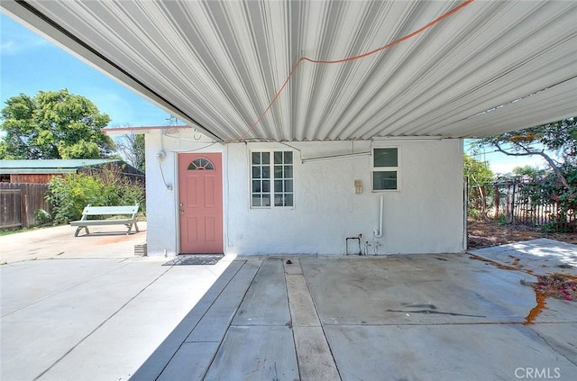 1507 4th St, Norco, CA 92860 - view of exterior entry with stucco siding, a patio area, and an attached carport