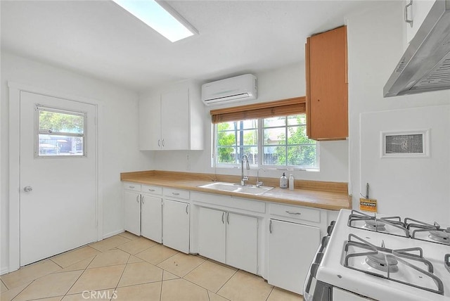 1507 4th St, Norco, CA 92860 - kitchen with a wall mounted air conditioner, under cabinet range hood, white gas range oven, light countertops, and plenty of natural light