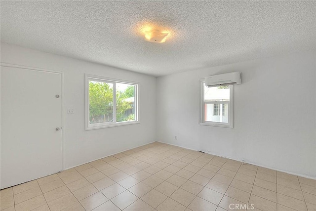 1507 4th St, Norco, CA 92860 - spare room featuring an AC wall unit, healthy amount of natural light, a textured ceiling, and light tile patterned floors