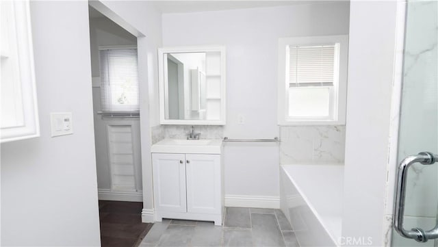1541 N Stanley Ave, Los Angeles, CA 90046 - full bath with plenty of natural light, vanity, a garden tub, and tile patterned flooring