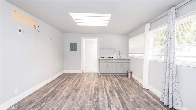 1541 N Stanley Ave, Los Angeles, CA 90046 - empty room featuring electric panel, wood finished floors, plenty of natural light, and baseboards