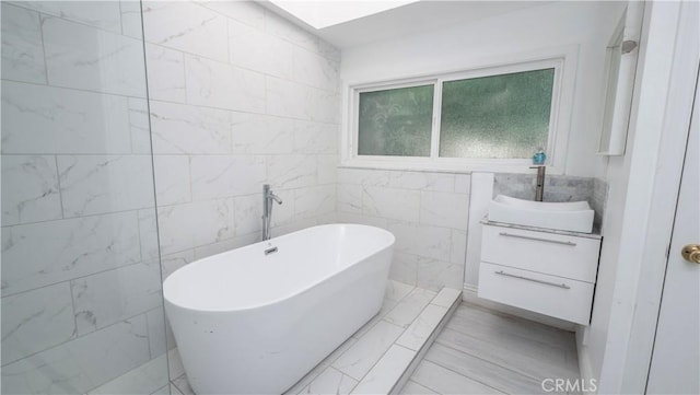 1541 N Stanley Ave, Los Angeles, CA 90046 - full bathroom featuring tile walls, a soaking tub, and vanity