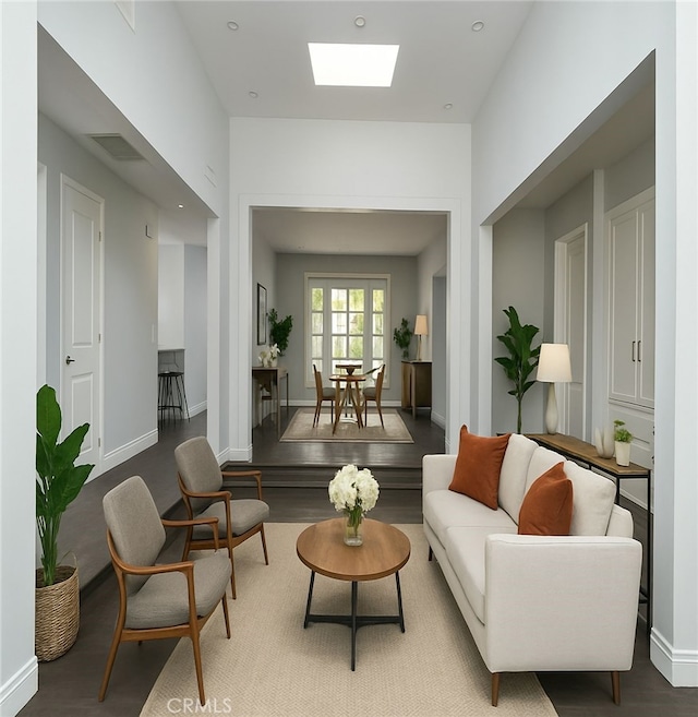 1541 N Stanley Ave, Los Angeles, CA 90046 - living room with a skylight, baseboards, and wood finished floors