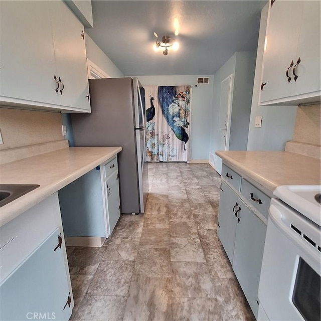 3473 Mclean St, Eureka, CA 95501 - kitchen with light countertops, white range with electric cooktop, baseboards, and stone finish flooring