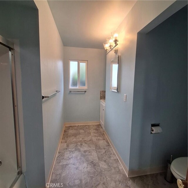3473 Mclean St, Eureka, CA 95501 - full bath featuring vanity, baseboards, a chandelier, toilet, and a shower with shower door
