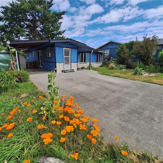 3473 Mclean St, Eureka, CA 95501 - view of front of house with driveway, stone siding, and a carport