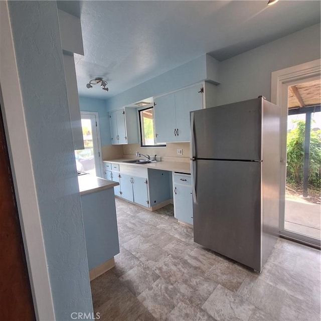 3473 Mclean St, Eureka, CA 95501 - kitchen featuring freestanding refrigerator, a sink, light countertops, and plenty of natural light