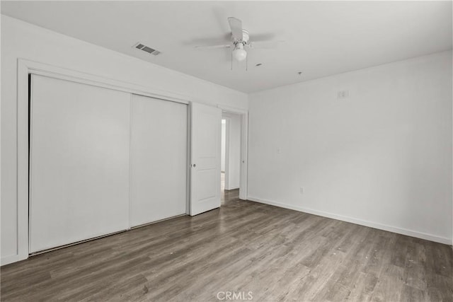 821 W 43rd Pl, Los Angeles, CA 90037 - unfurnished bedroom with wood finished floors, a closet, baseboards, and a ceiling fan