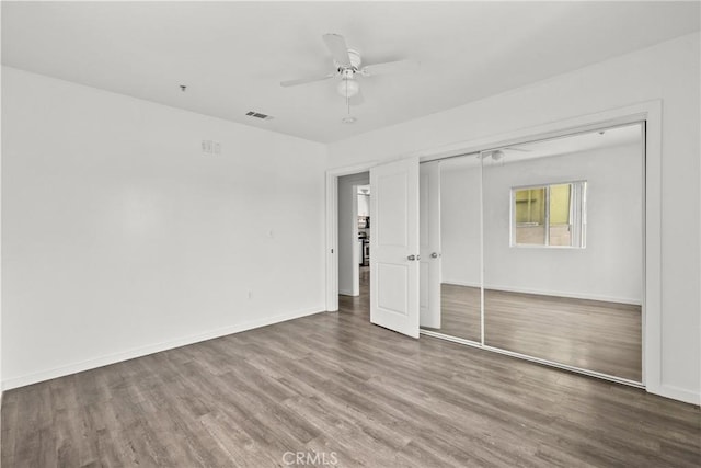 821 W 43rd Pl, Los Angeles, CA 90037 - unfurnished bedroom with wood finished floors, a closet, baseboards, and ceiling fan
