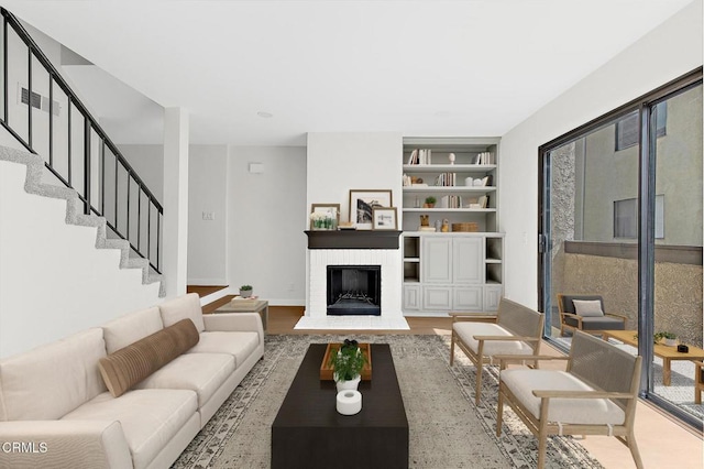 11940 Weddington St Unit 19, Valley Village, CA 91607 - living area with stairs, a fireplace, built in features, and light wood-style flooring