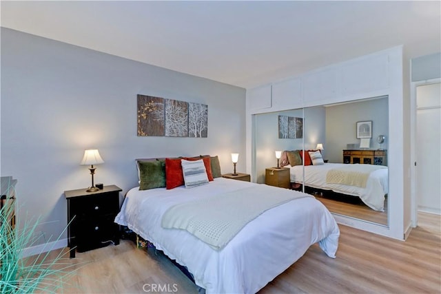 2109 Via Puerta Unit A, Laguna Woods, CA 92637 - bedroom featuring light wood-type flooring, baseboards, and a closet