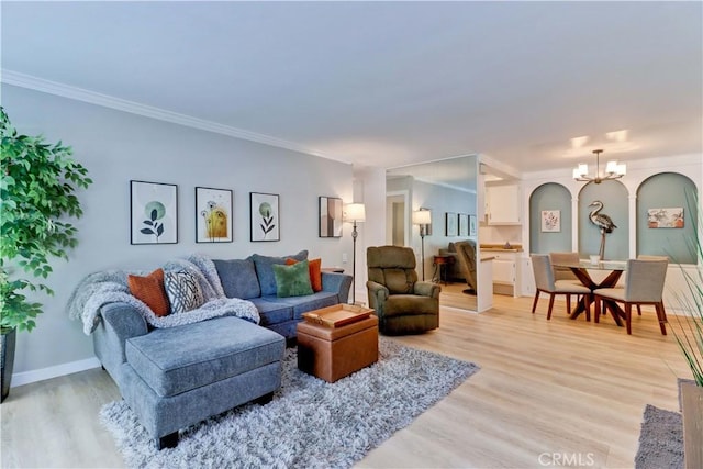 2109 Via Puerta Unit A, Laguna Woods, CA 92637 - living room with a chandelier, light wood-type flooring, crown molding, arched walkways, and baseboards
